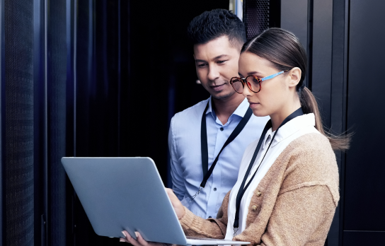 Image of a man and a woman looking at a laptop