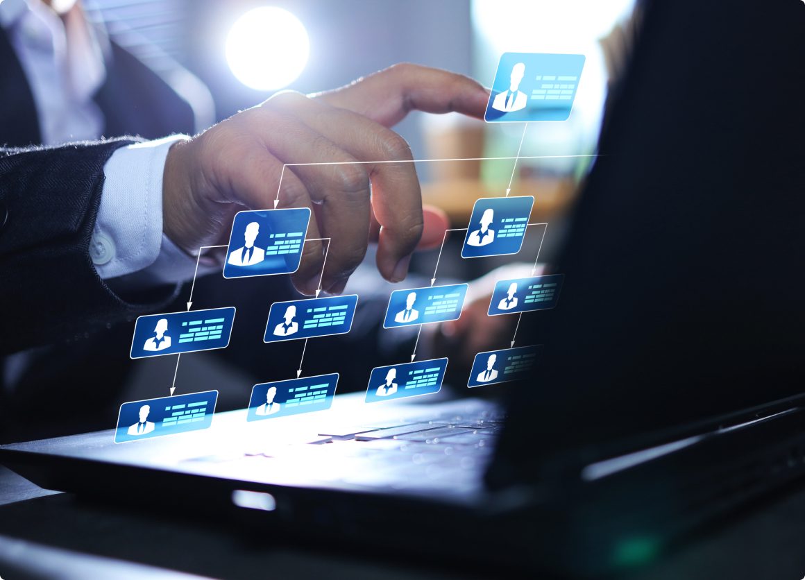 Image of a man using a laptop and about to touch the screen to edit a flowchart 