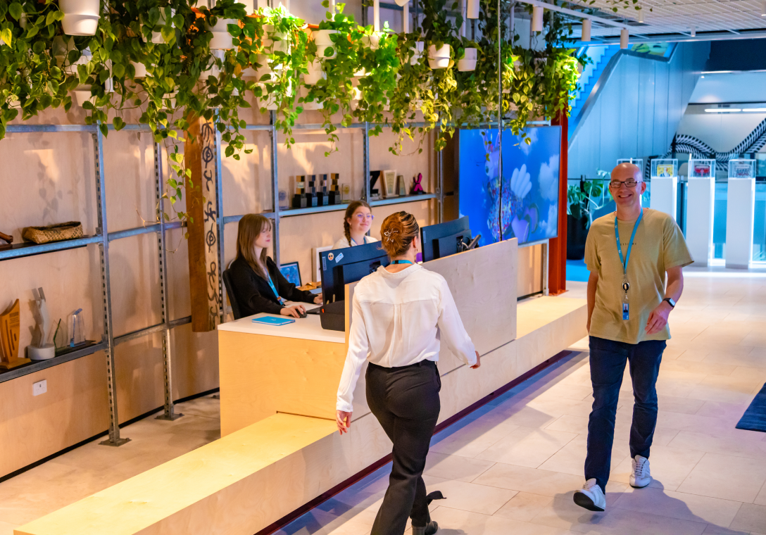 Photo of inside to 2degrees office at reception with workers walking through