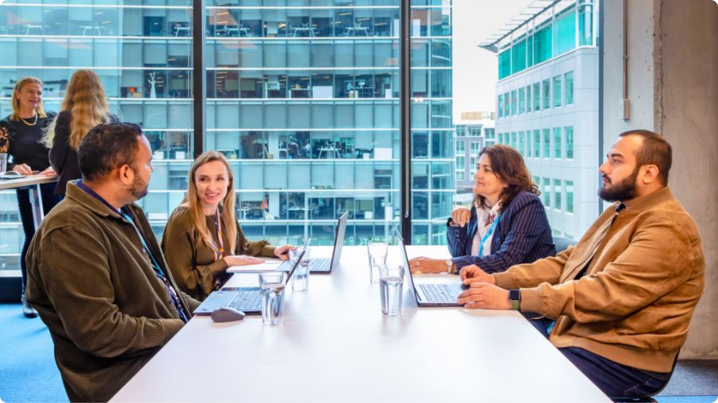 Photo of staff members sitting around a table having a meeting