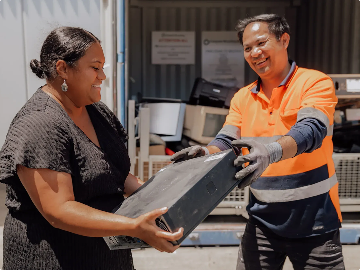 Lady handing over an old computer system