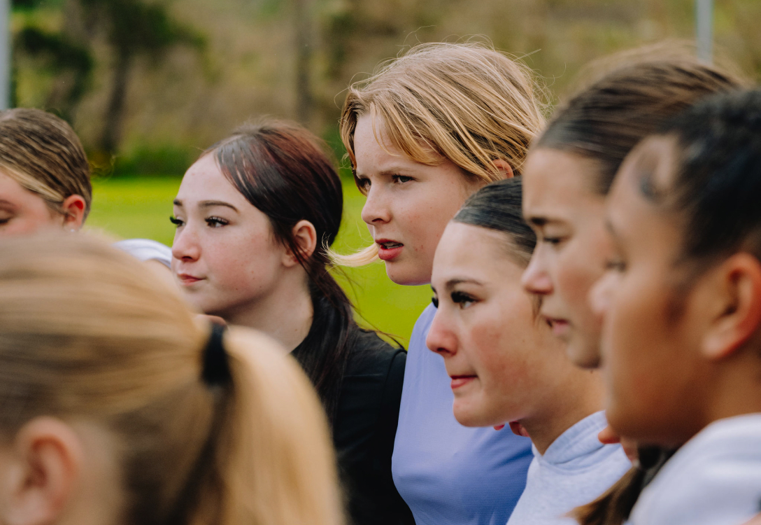 Photo of girls standing in a huddle