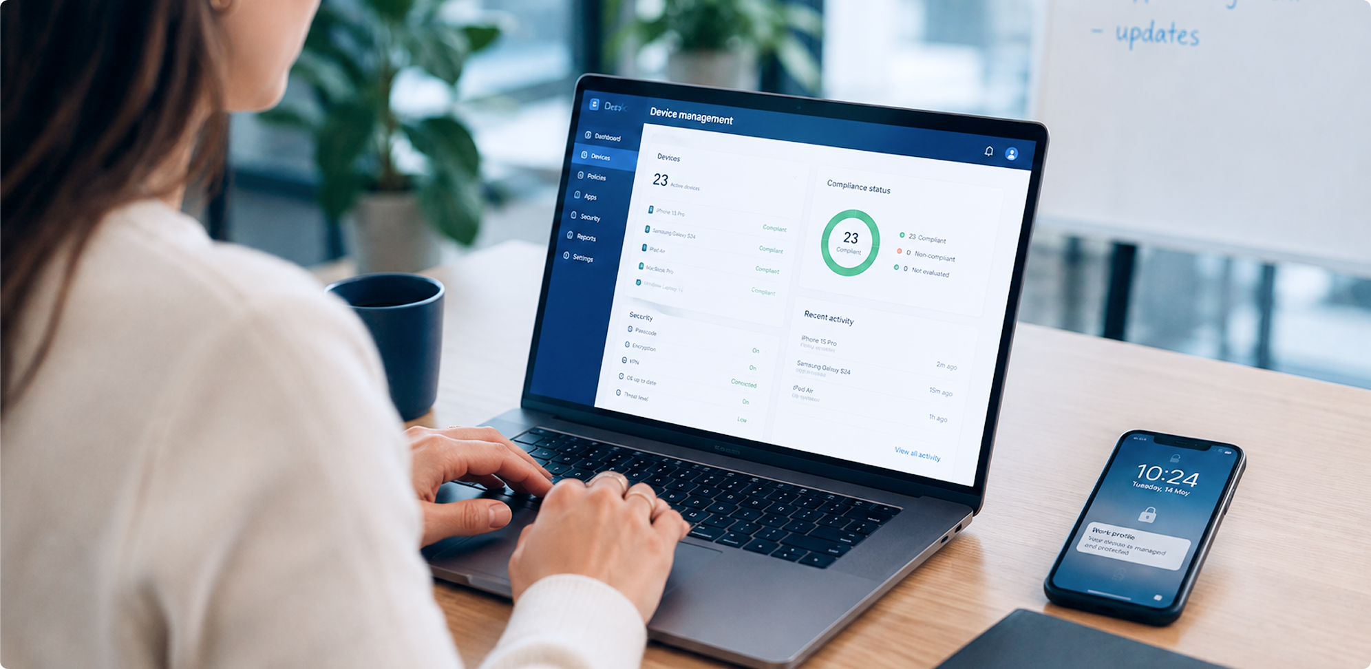 Image of a woman sitting at a laptop with the device management screen open
