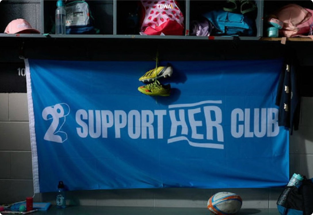 Photo of the SupportHER Club Flag inside a changing room