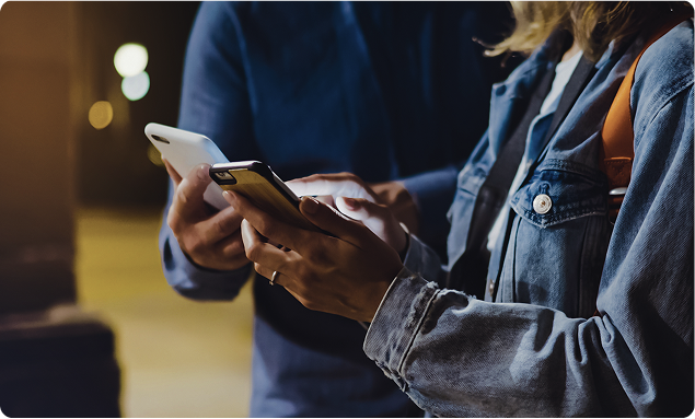Image of a guy and a girl holding mobile phones in their hands