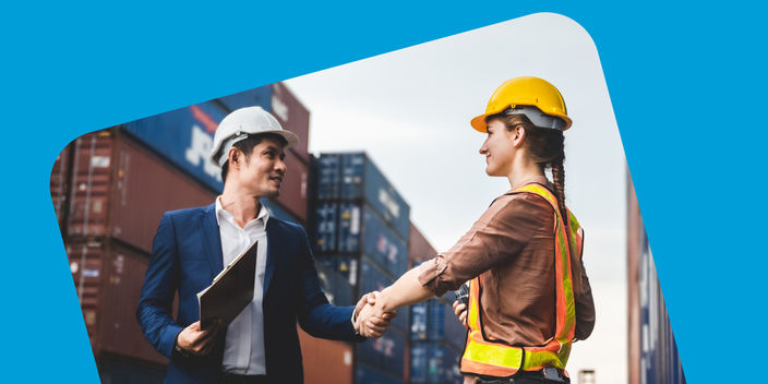 man and woman shaking hands on a construction site