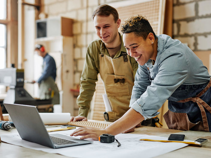 two men using laptop